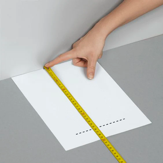 Measure from the edge of the paper to the mark in mm. This is your foot length